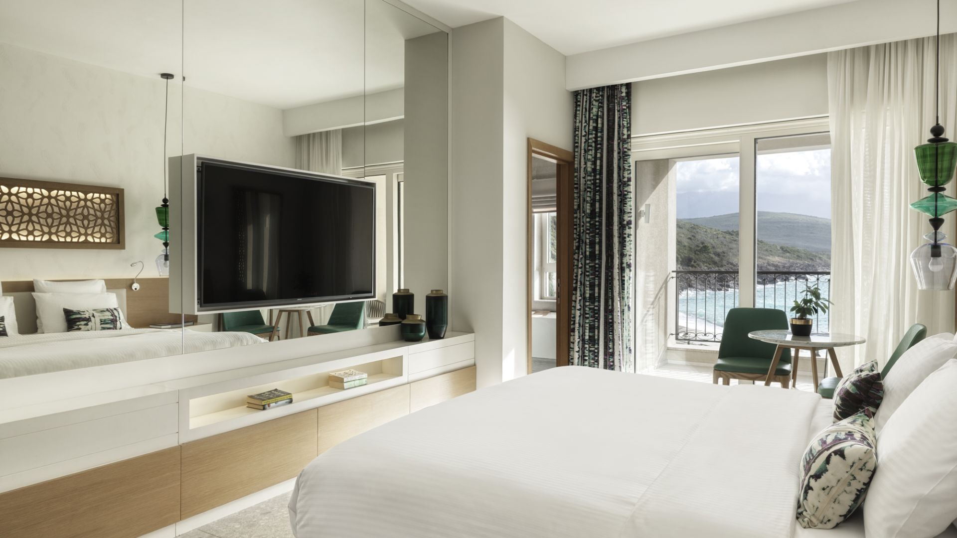 A Large Bedroom With A Large Television