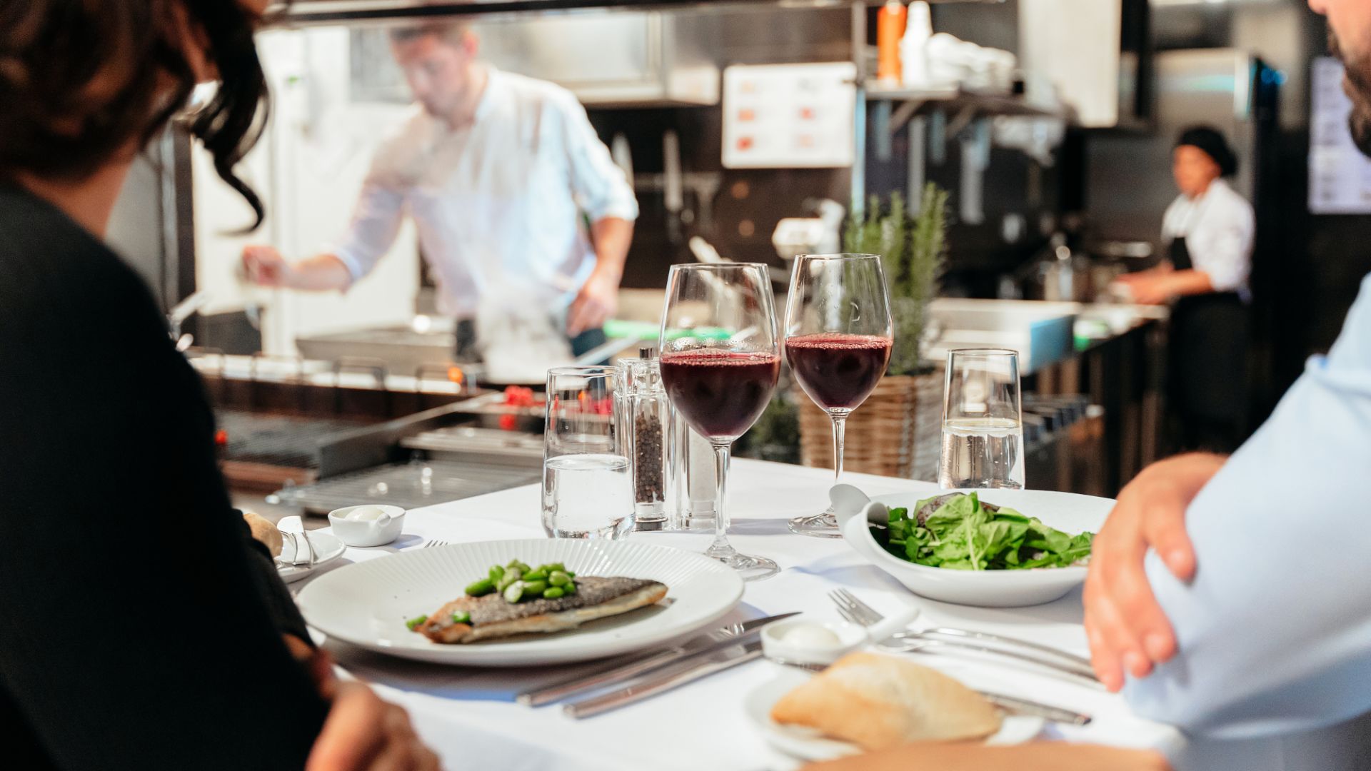 People Sitting At A Table With Food And Drinks