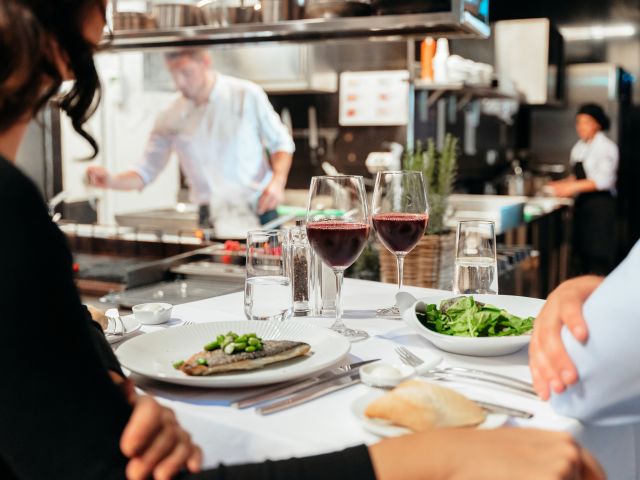 People Sitting At A Table With Food And Drinks